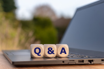 Symbol for Questions and Answers. Cubes placed on a notebook with the letters 