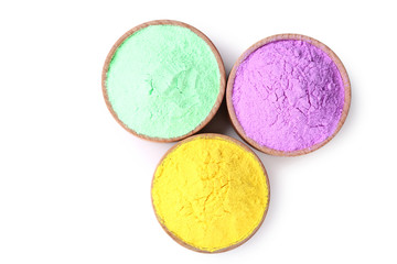 Fototapeta na wymiar Colorful holi powder in bowls on white background