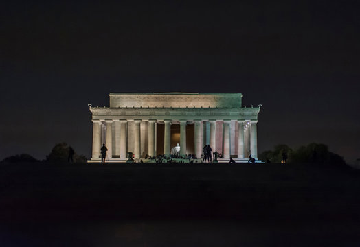Silhouette people at Lincoln Memorial against clear sky at night