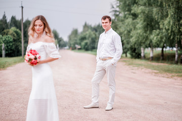 Fototapeta premium Bride and groom posing on the road