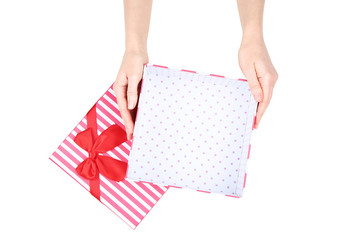 Female hands holding gift box on white background