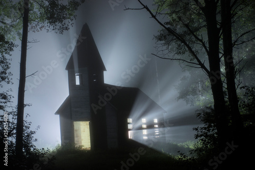 Light emitting from old church in forest at night
