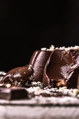 dark chocolate and biscuit pudding. White chocolate and cocoa decorations. Spoonful to show the inside 