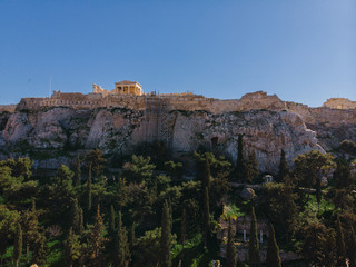 Fototapeta na wymiar City views of day time with acropolis on a hill at the horizon, Athens, Greece