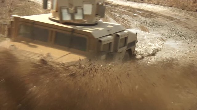 Military vehicle driving on sandy terrain 12