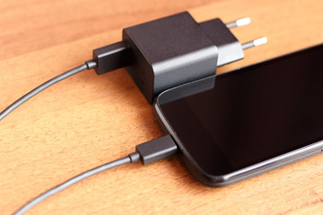 Phone charger usb cable lay on the table