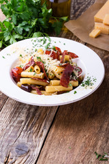 Rigatoni pasta with salami, roasted cherry tomatoes, and olives