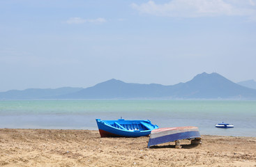 View on the empty beach with boats in Tunisia