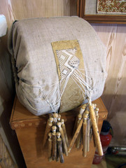 Fototapeta na wymiar Pillow for weaving a pattern of threads with bobbins