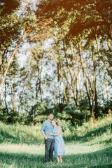 Happy young family spending time together outside in green nature