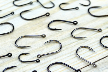laid out on a wooden Board fishing hooks in a chaotic manner