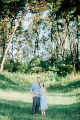 Happy young family spending time together outside in green nature