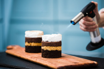 Homemade smores dessert being toasted with a hand torch