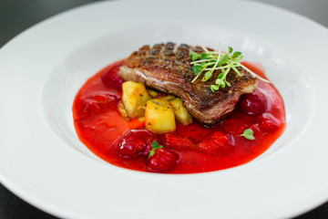 Steak  from fillet of a duck with caramelized strawberry and an eggplant
