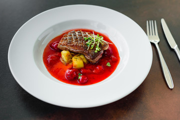 Steak  from fillet of a duck with caramelized strawberry and an eggplant