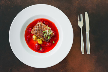 Steak  from fillet of a duck with caramelized strawberry and an eggplant