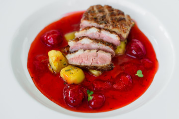 Steak  from fillet of a duck with caramelized strawberry and an eggplant