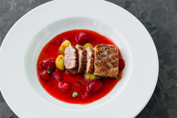 Steak  from fillet of a duck with caramelized strawberry and an eggplant