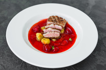 Steak  from fillet of a duck with caramelized strawberry and an eggplant