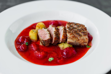 Steak  from fillet of a duck with caramelized strawberry and an eggplant