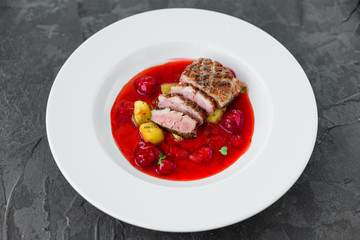 Steak  from fillet of a duck with caramelized strawberry and an eggplant