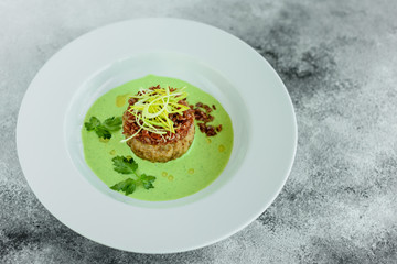 Meat dish with rice, onions slices, greens and sauce