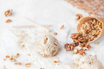 Honey and yogurt Ice Cream with shelled walnuts in cone