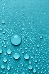 Light blue surface with clear water drops, background