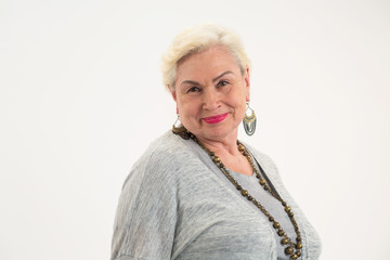Isolated elderly woman. Senior lady smiling. Confidence and optimism.