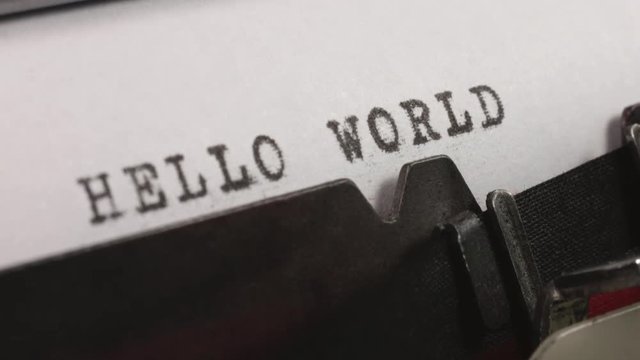 Typing HELLO WORLD on an old manual typewriter.