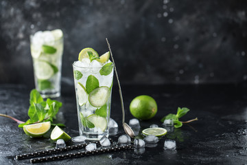 Mojito cocktail with lime and mint in highball glass on a dark stone background. Fresh summer cocktail