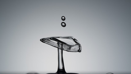 Fototapeta na wymiar Close-up of a water drop falling on water surface