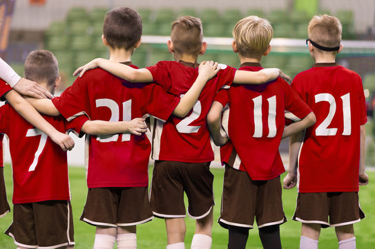 Children in Sportswear Standing in Team. Kids in Red Jersey Shirts. Kids Standing in Row During Penalty Kicks © matimix