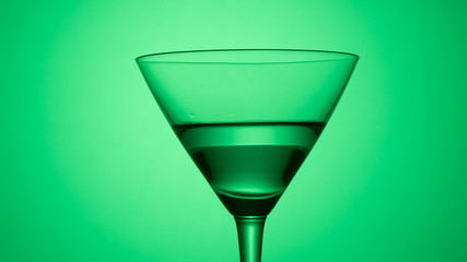 Martini glass on color background