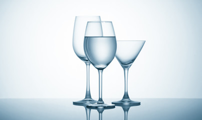 Glasses with water on blue background