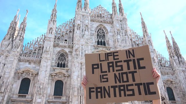 Picket sign 1st global strike for climate day, Duomo building, cathedral square, Milan, Italy. Friday for future ecological movement, placard environmental activism "LIFE IN PLASTIC IS NOT FANTASTIC"