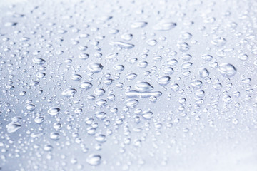 Drops of water on a gray background closeup