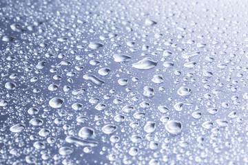 Drops of water on a gray background closeup
