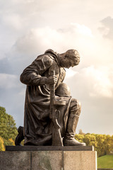 Statue of kneeling Soviet soldier at the Soviet War Memorial in Treptower Park in Berlin
