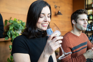 two friends drinking wine in cafe