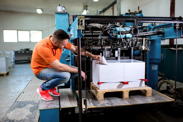 Fototapeta na wymiar Man working in printing factory