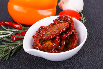 Dried tomatoes in the bowl with olive oil