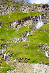 A young man at the alpine waterfall