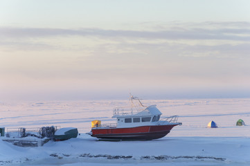 Motorboat on the riverbank in winter