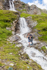 Fototapeta na wymiar A father and son at the alpine waterfall