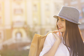Fototapeta premium Beautiful happy woman shopping at the city