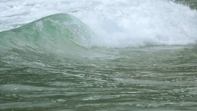Turquoise rolling wave, slow motion