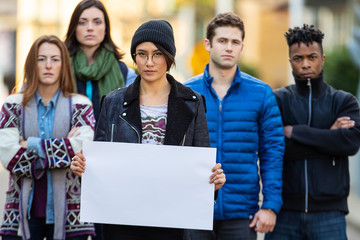 Group of protesters holding a blank sign during demonstration