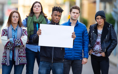 Group of protesters holding a blank sign during demonstration