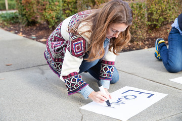 Activist woman writing protest message demanding equality